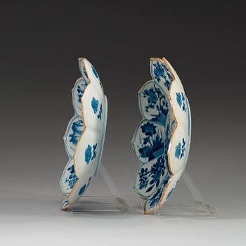 Two blue and white dishes of lotus shape decorated with flowers and insects, Qing dynasty, Kangxi (1662-1722).