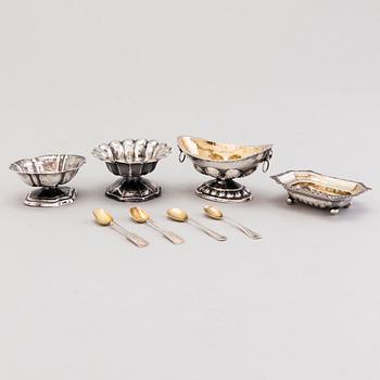 Four Russian 19th Century silver salt cellars and four Finnish 1920s parcel-gilt salt spoons.