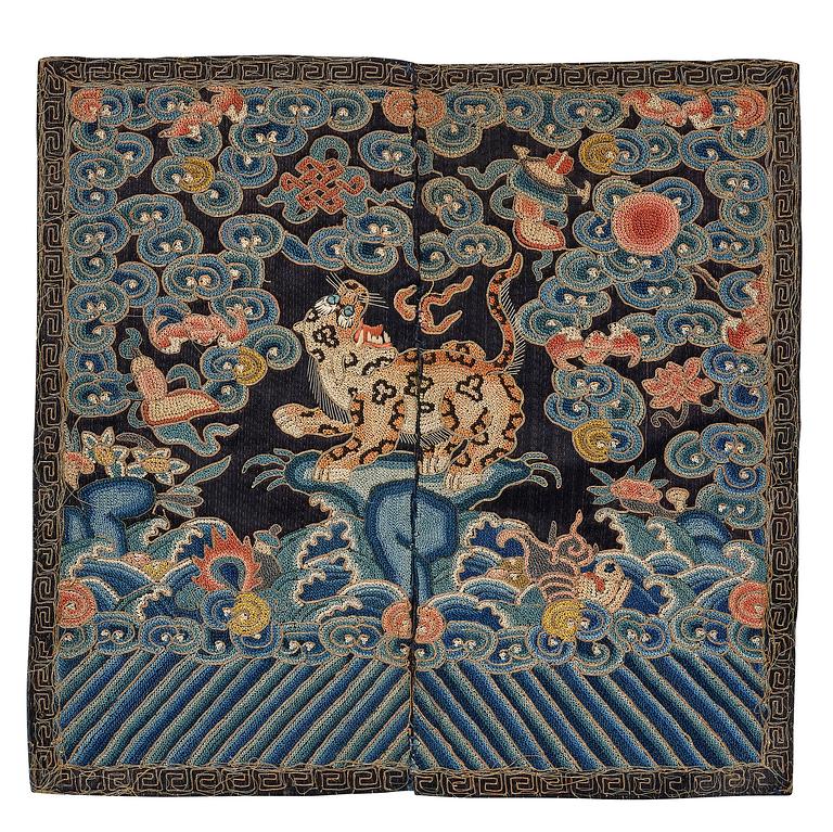 An embroidered black satin military official rank badge of a leopard, Buzi, Qing dynasty, mid 19th Century.