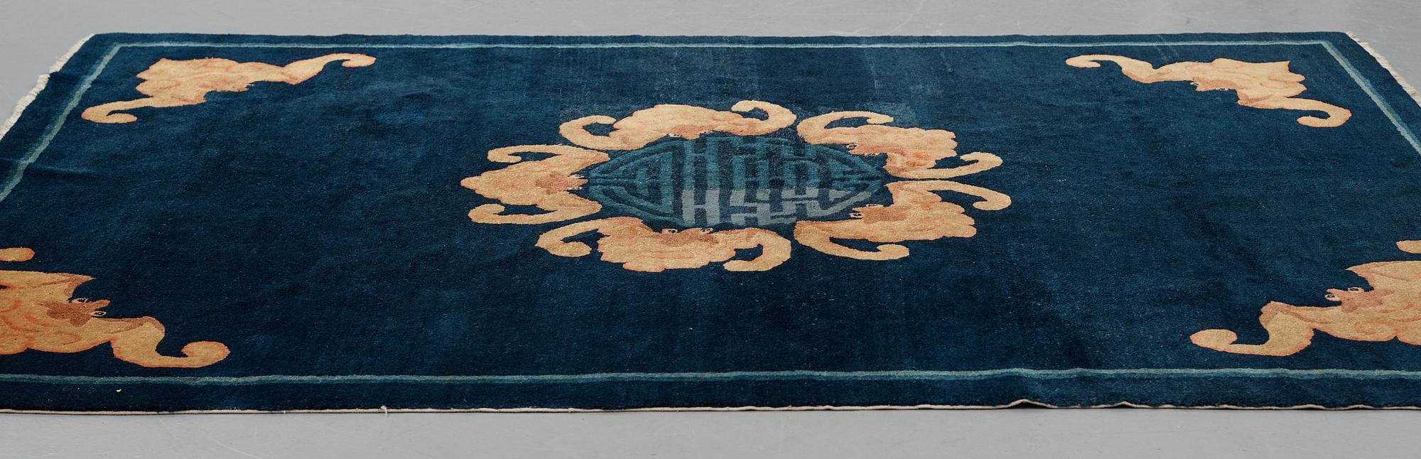 A carpet, a semi-antique Chinese,  ca 255 x 199-202,5 cm.