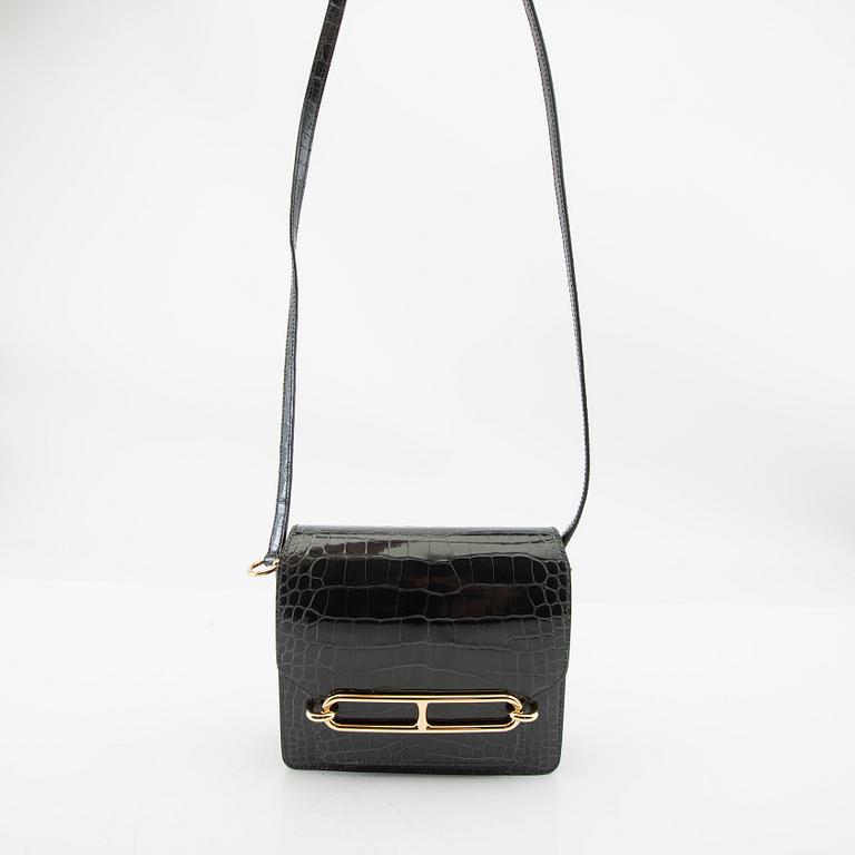 Hermès, bag "Green Shiny Alligator Mini Roulis 18 Permabrass Hardware" 2021.