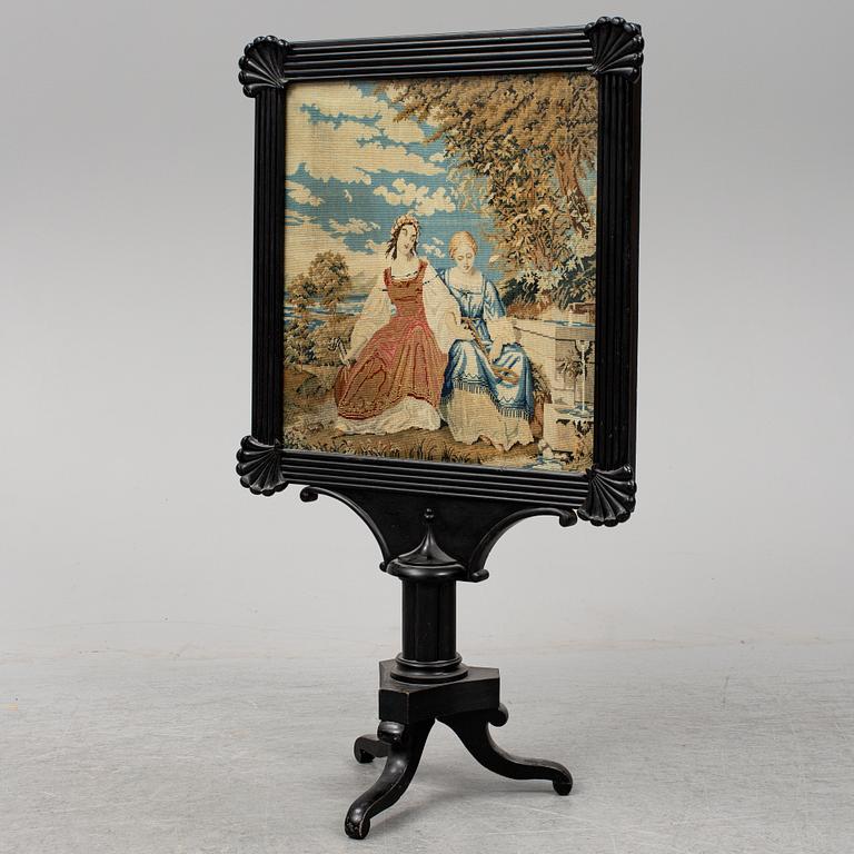 A mid 19th century fire screen.