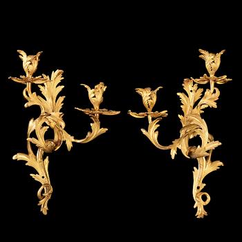 1236. A pair of Rococo 18th century gilt bronze two light wall-lights.