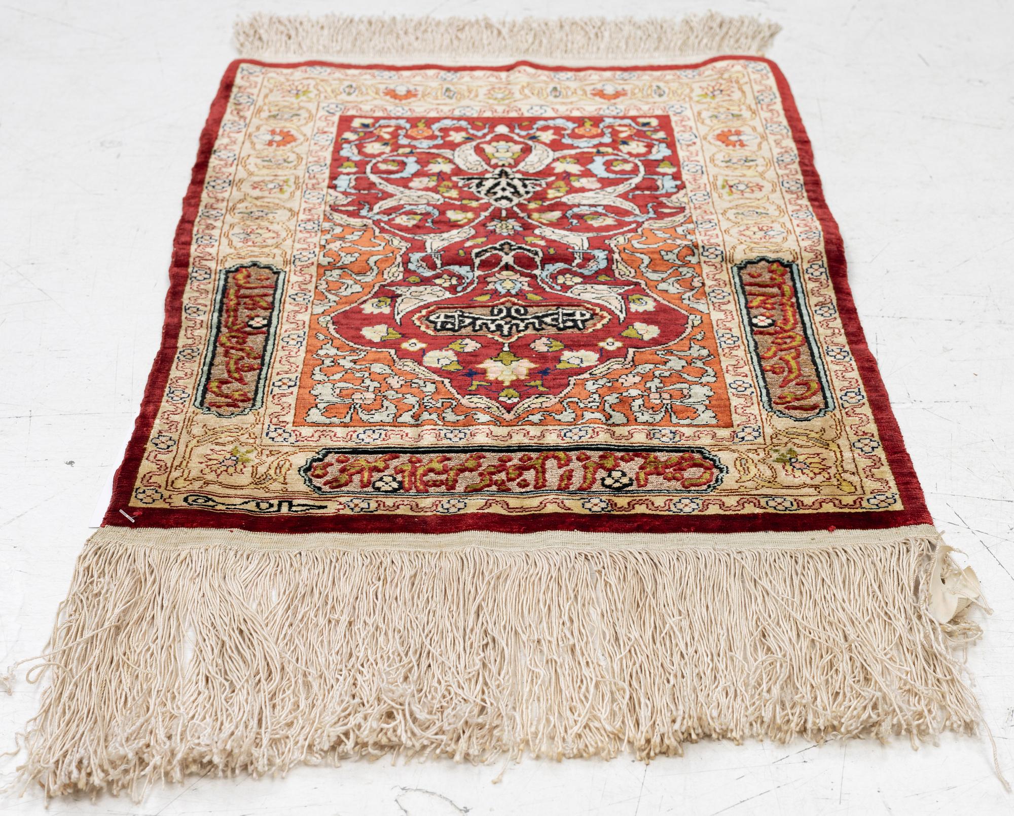 A silk and metal Hereke rug, West Anatolia, c. 58 x 39 cm.