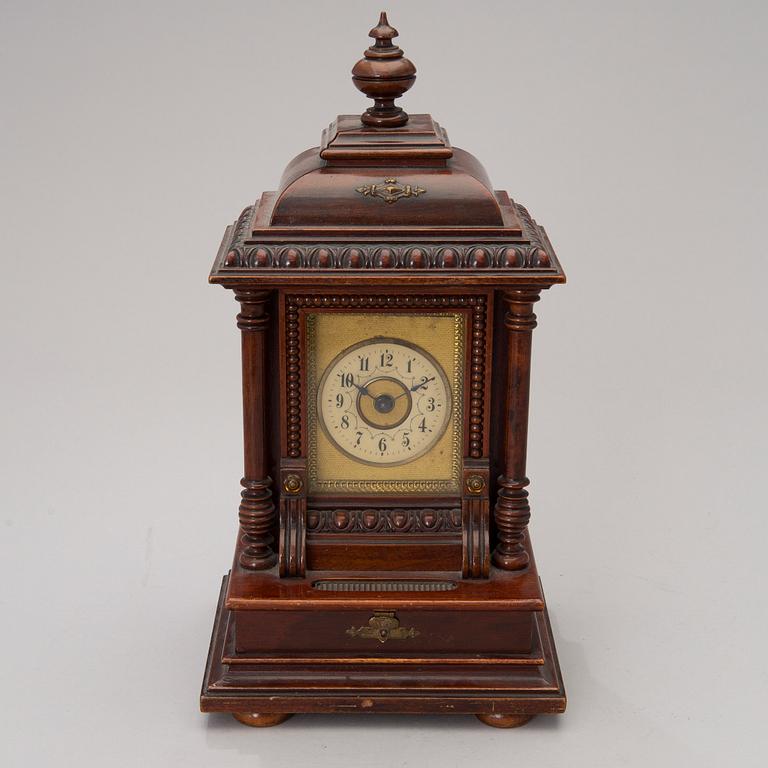 An early 20th century German Junghans table clock with music box.