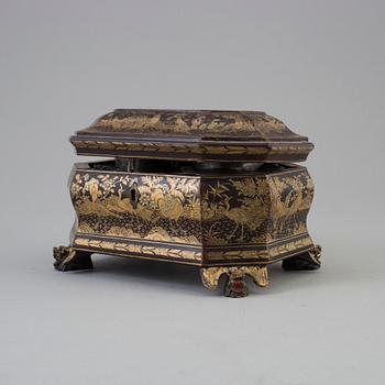 A Chinese lacquered box with cover with two pewter tea caddies, Qing dynasty, 19th Century.