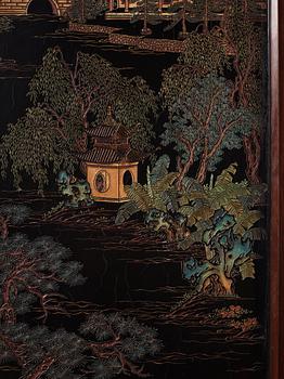 A set of four Chinese lacquer panels with wooden frames, early 20th century.