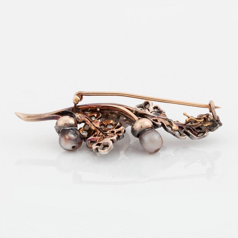 A silver and gold brooch set with pearls and rose-cut diamonds.