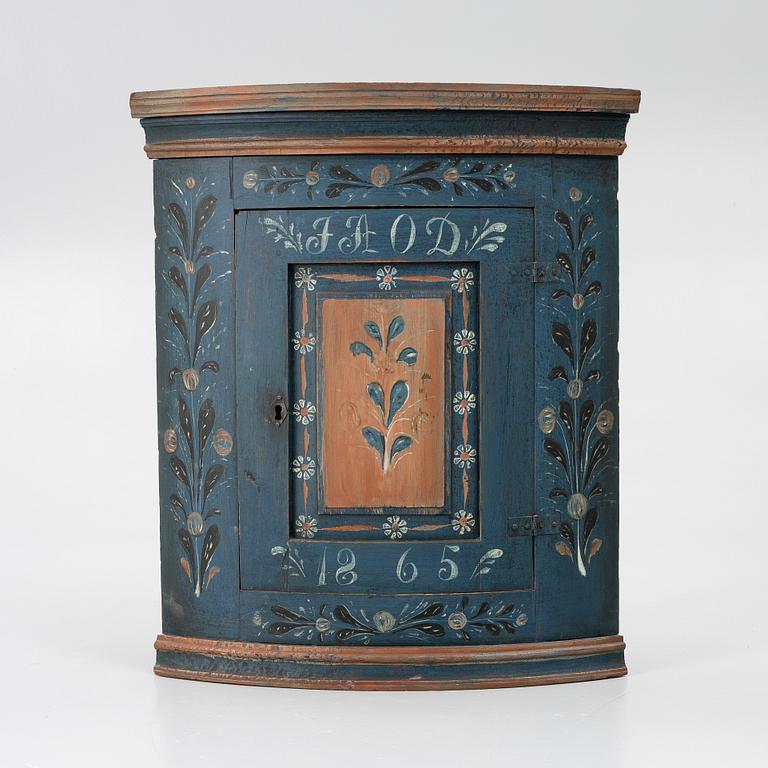 A folk art corner cabinet from Delsbo, Hälsingland, dated 1865.