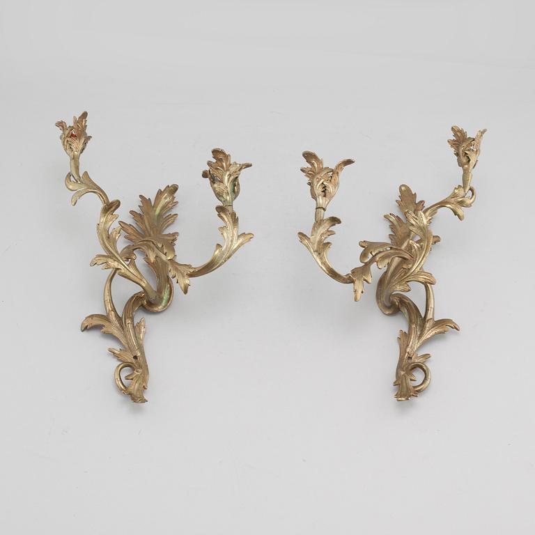 A pair of Louis XV-style brass wall sconces first half of the 20th century.