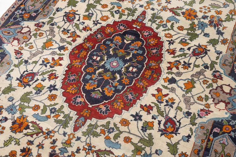 A Tabriz rug, signed, approx. 239 x 153 cm.