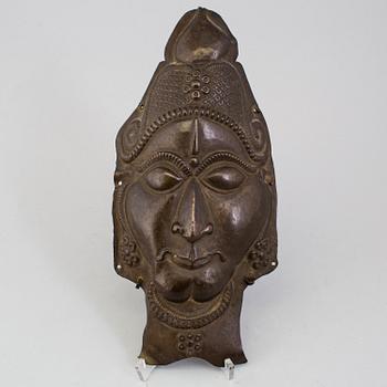 A copper alloy mask of a deity, south east asia, presumably 19th Century.