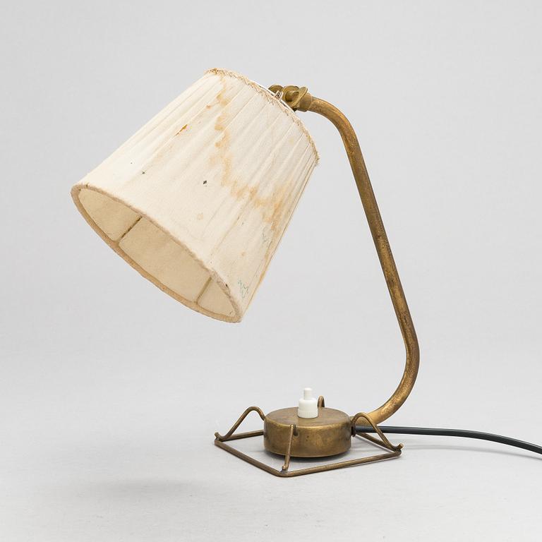 A mid-20th-century table lamp
/wall light for Idman.