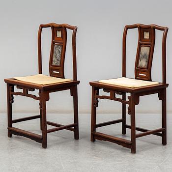 A pair of Chinese hardwood armchairs, early 20th century.