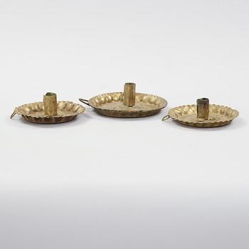 three brass candle holders from the 18th century.