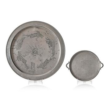 Firma Svenskt Tenn, a set of two pewter trays, Stockholm, 1930 and 1927.