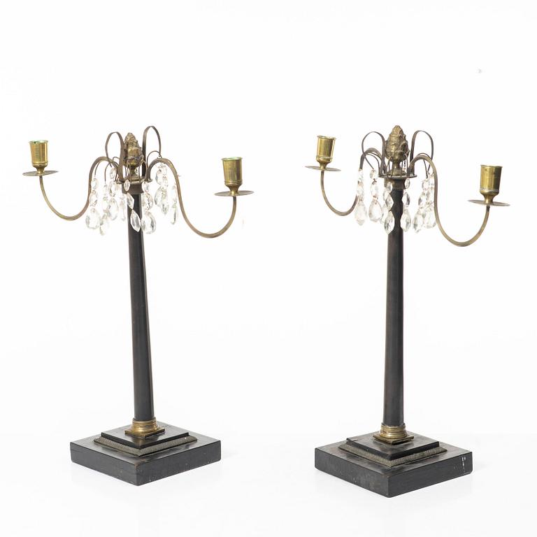 A pair of wooden candelabras, around 1900.