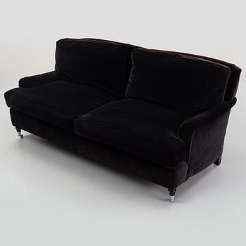 A contemporary velvet Howard sofa.