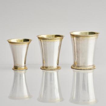Three Swedish 18th century parcel-gilt silver beakers and a case of birch, different maker's.