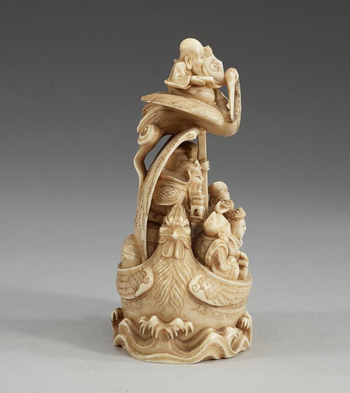 A carved sectional ivory group of Shou Lao with his crane and seven immortals in a boat, Qing dynasty, circa 1900, signed.