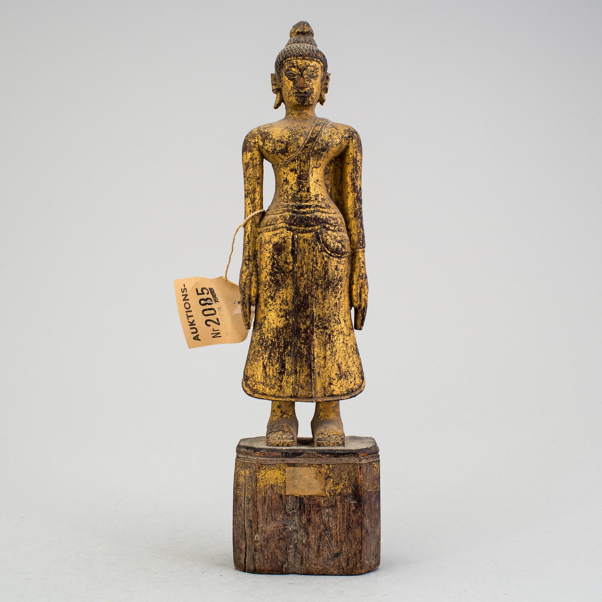 A Burmese sculpture of a standing buddha, circa 1900.