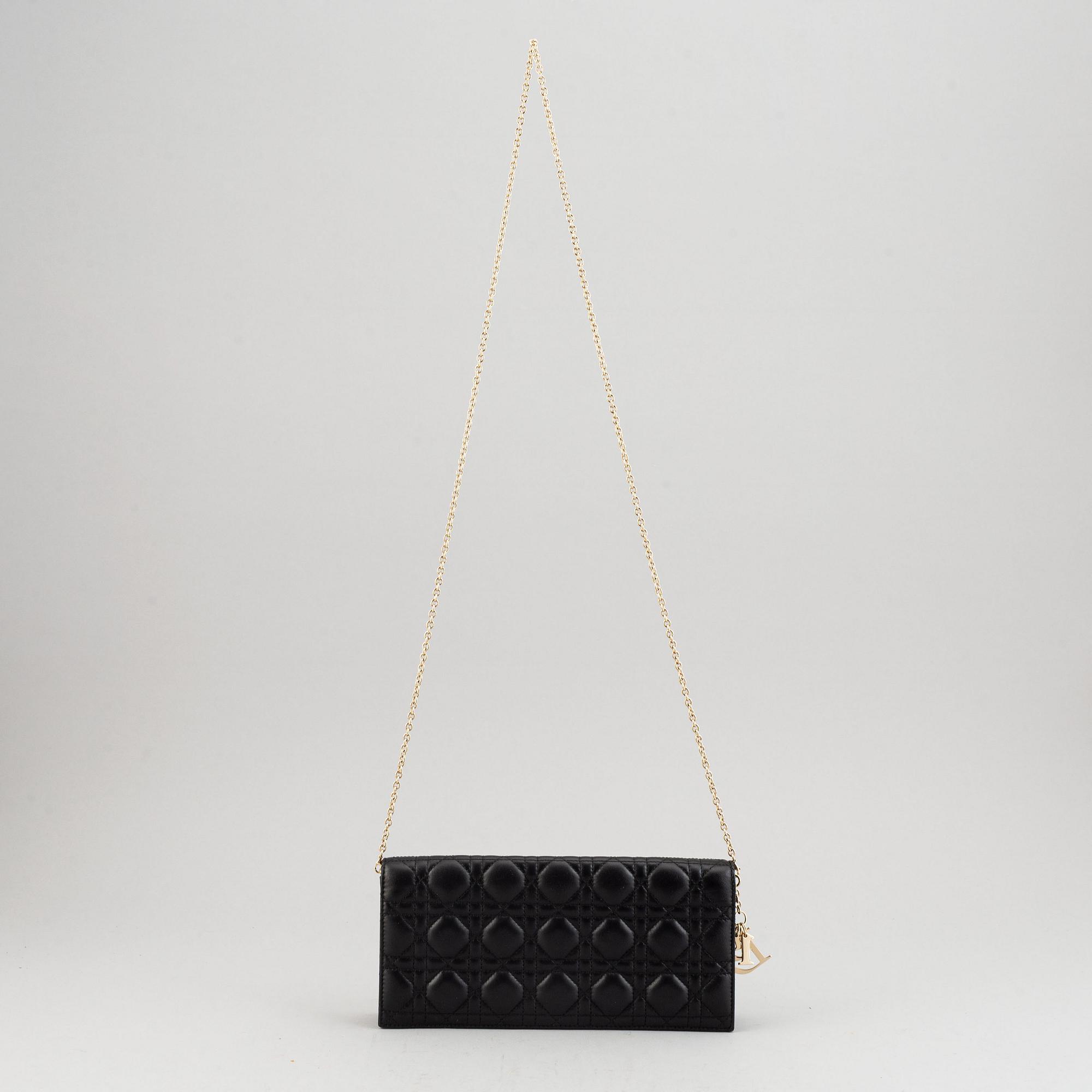 Christian Dior, a quilted leather handbag/clutch.
