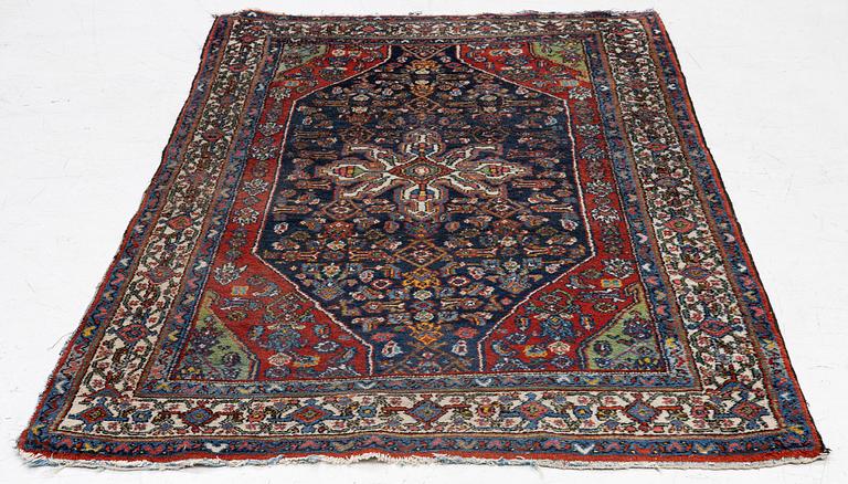 An oriental, semi-antique rug, c. 195 x 130 cm.