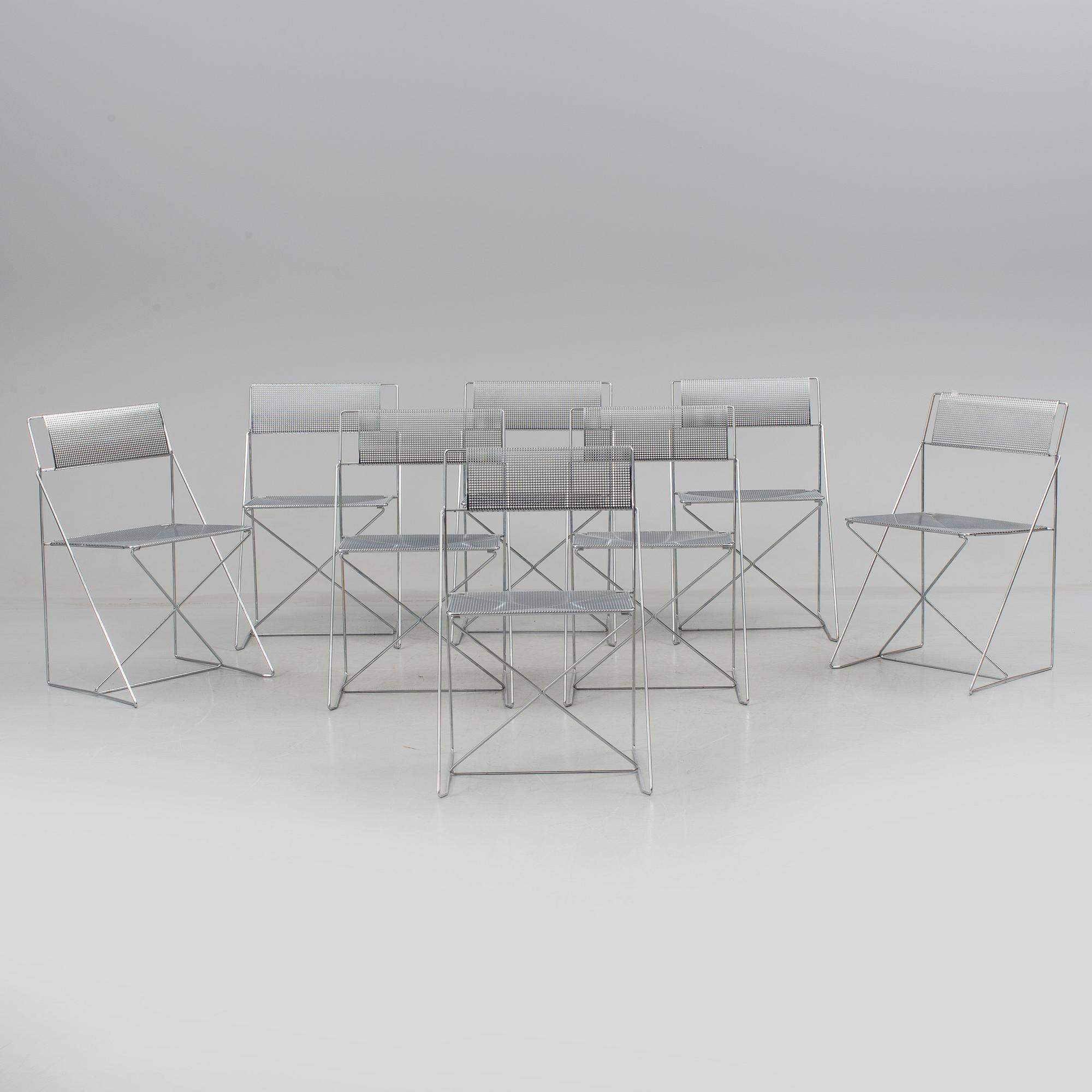 8 contemporary stackable metal chairs.