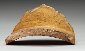 A yellow glazed end-tile, with dragon in relief, Ming dynasty (1368-1644).