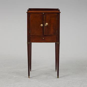 A first half of the 19th century mahogany veneered bedside table.