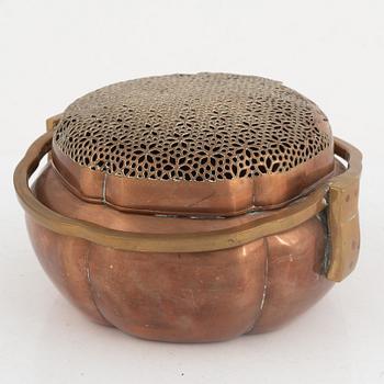 A Chinese copper handwarmer, late Qing dynasty.