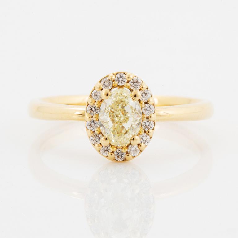 Oval light yellow diamond and brilliant-cut diamond ring.