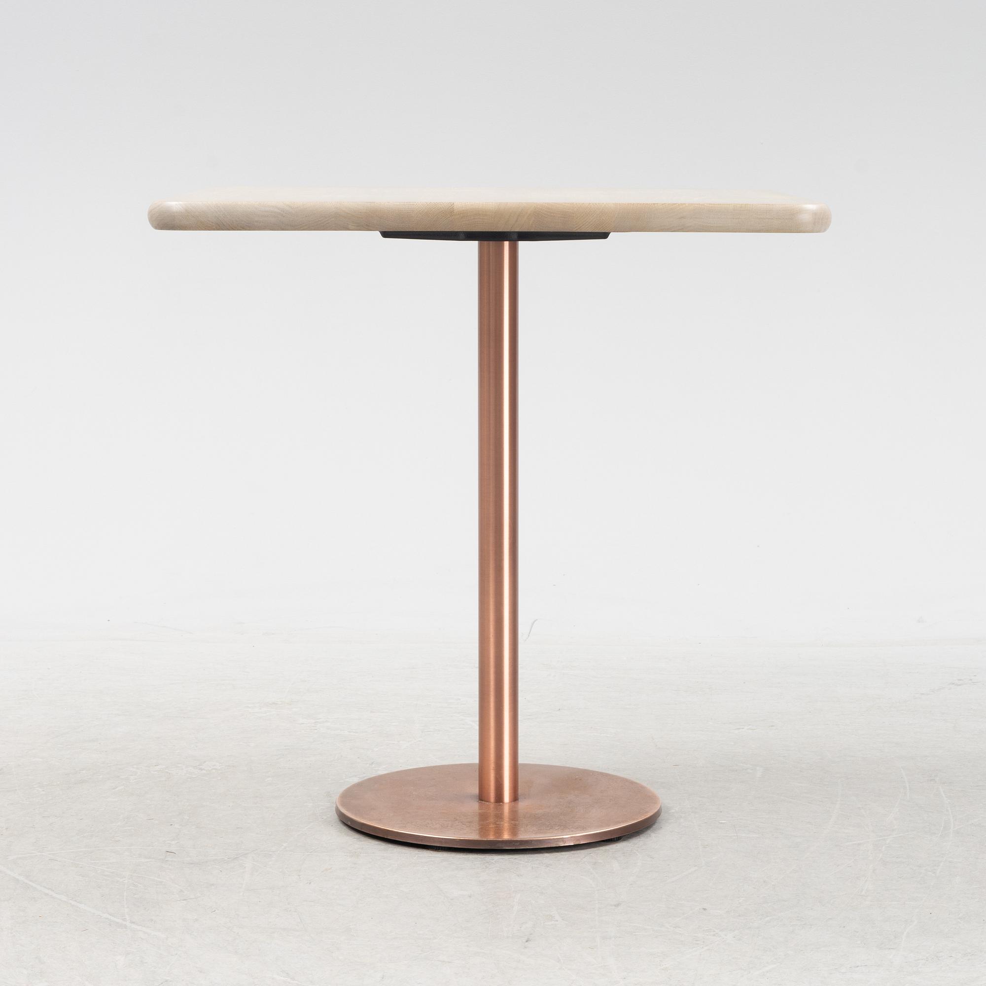 A steel and oak table by Jonas Lindvall 2011.