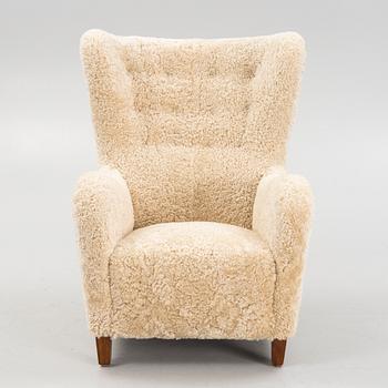 A variation of model 1672 new sheepskin upholstered lounge chair from Fritz Hansen.