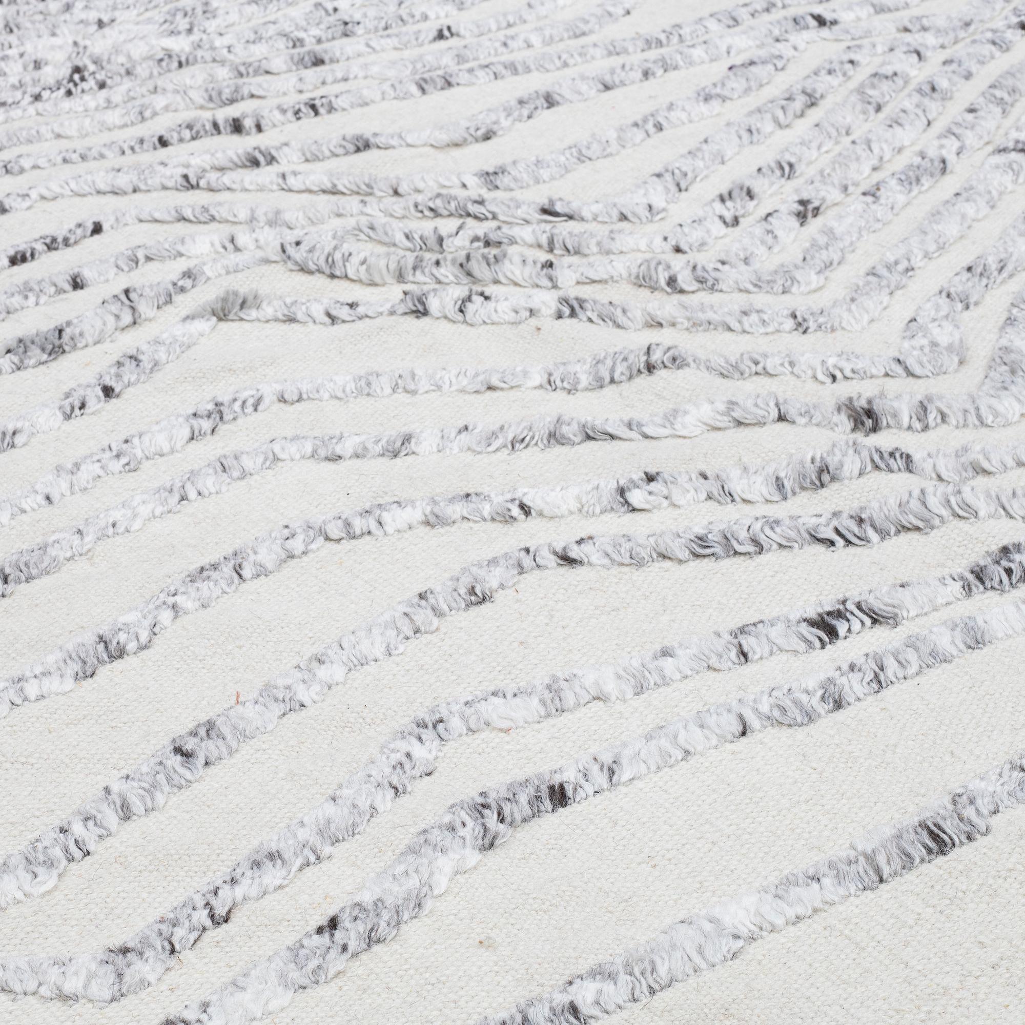A CARPET, flat weave, with knoted detalis in relief, ca 300 x 240 cm.