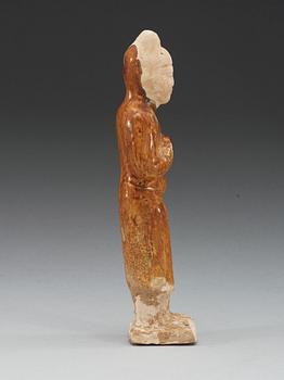 A yellow glazed pottery figure of a court attendant, Sui dynasty (589-618).