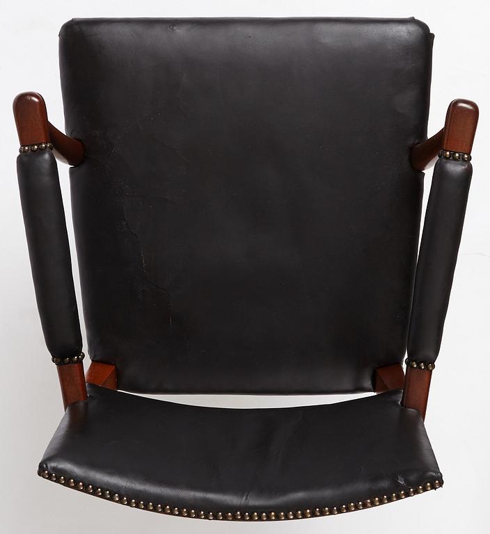 Josef Frank, a mahogany and black leather swivel chair, modified version of model 695, Svenskt Tenn, ca 1956-1957.