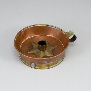 A 19th century copper and brass night light holder.