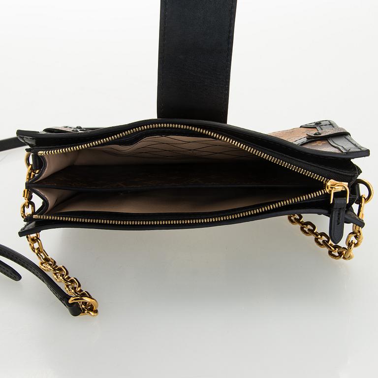 Louis Vuitton, a "Reverse Monogram Trunk Clutch" bag.
