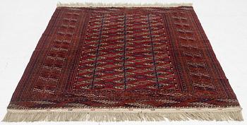 An oriental rug, c. 184 (+4cm flat weave on each end) x 133 cm.