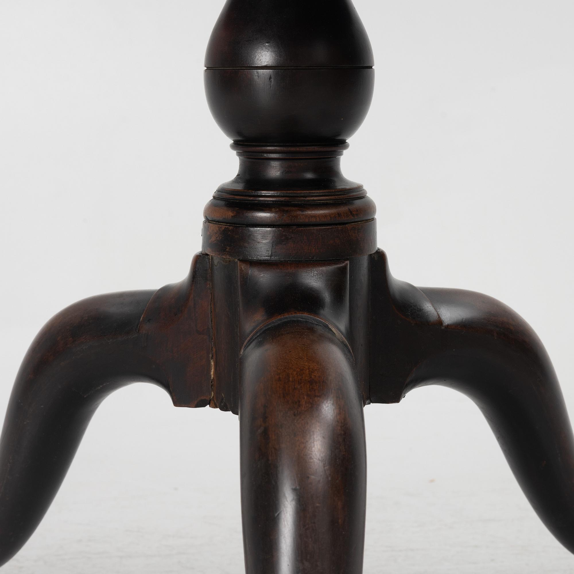 A mahogany three-tier table, England, circa 1900.