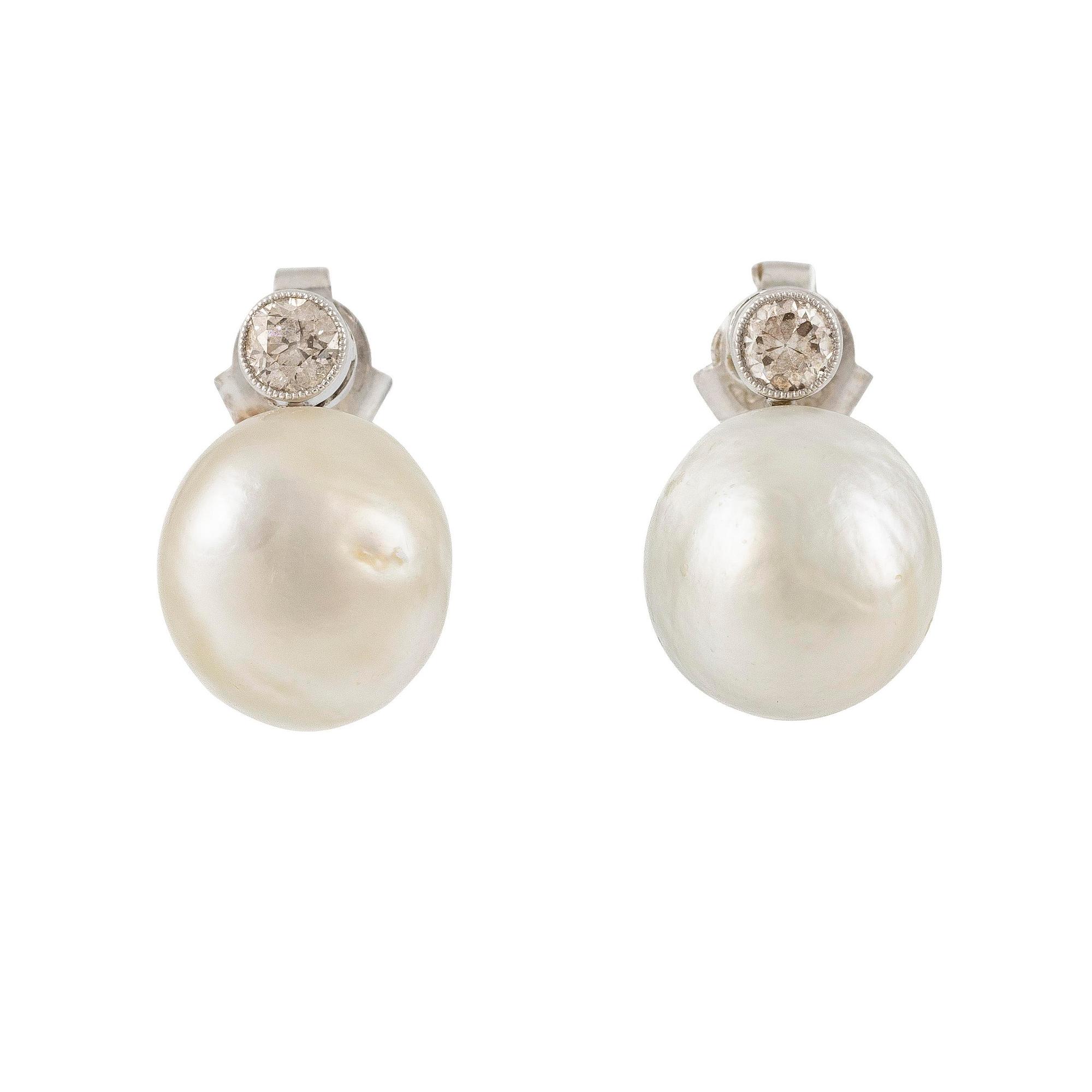 A pair of platinum earrings with bouton pearls and old-cut diamonds.