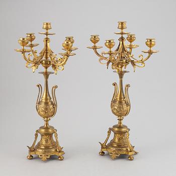 A pair of late 19th century brass candelabra for five candles.