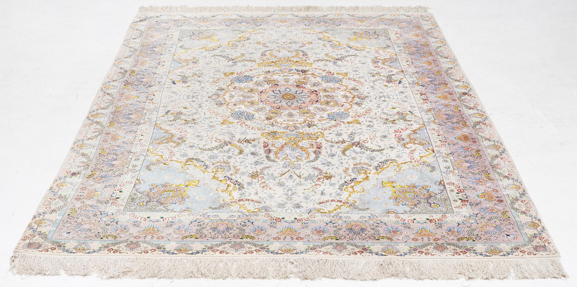 A Tabriz carpet north west Persia, part silk, c. 314 x 197 cm.