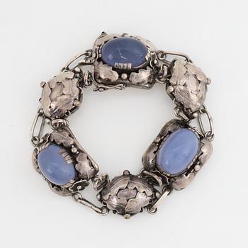 Bracelet, silver and cabochonslipade blue chalcedony, Gussi Smycken AB, Malmö, 1951.