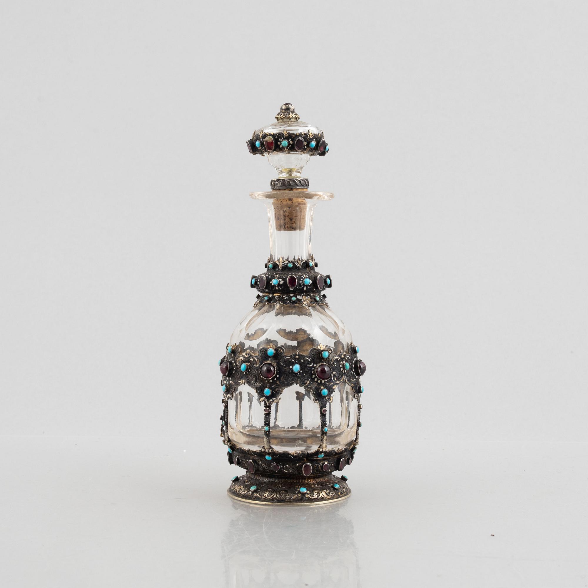 Flask with stopper, glass with mounts of partially gilded silver, late 19th century.