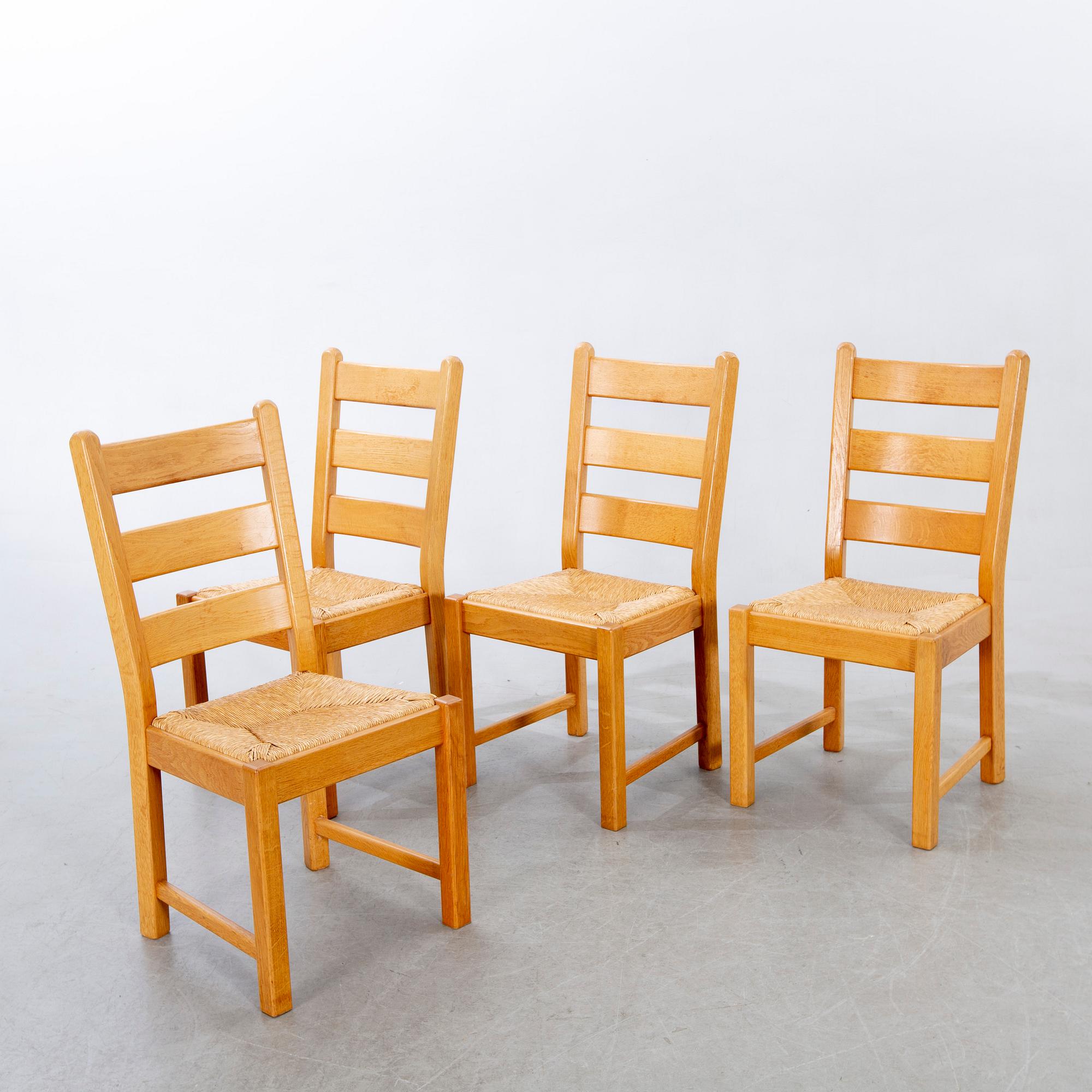 A set of four wicker and oak 1970s chairs.