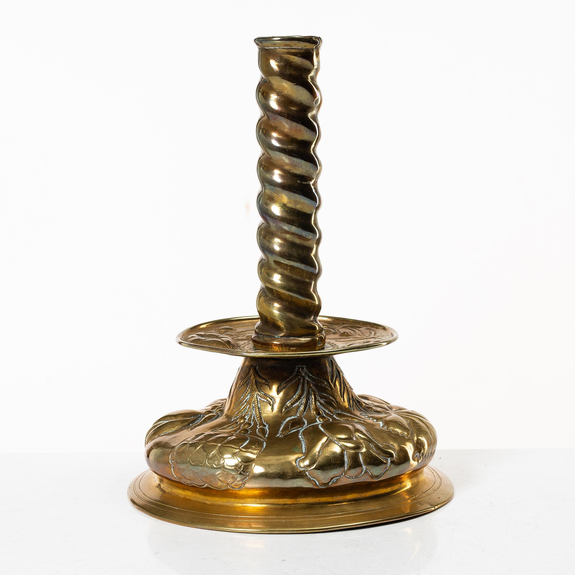 A Baroque brass candle stick, 18th century.