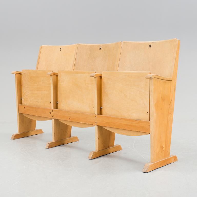 Three wooden cinema/ theatre seats.