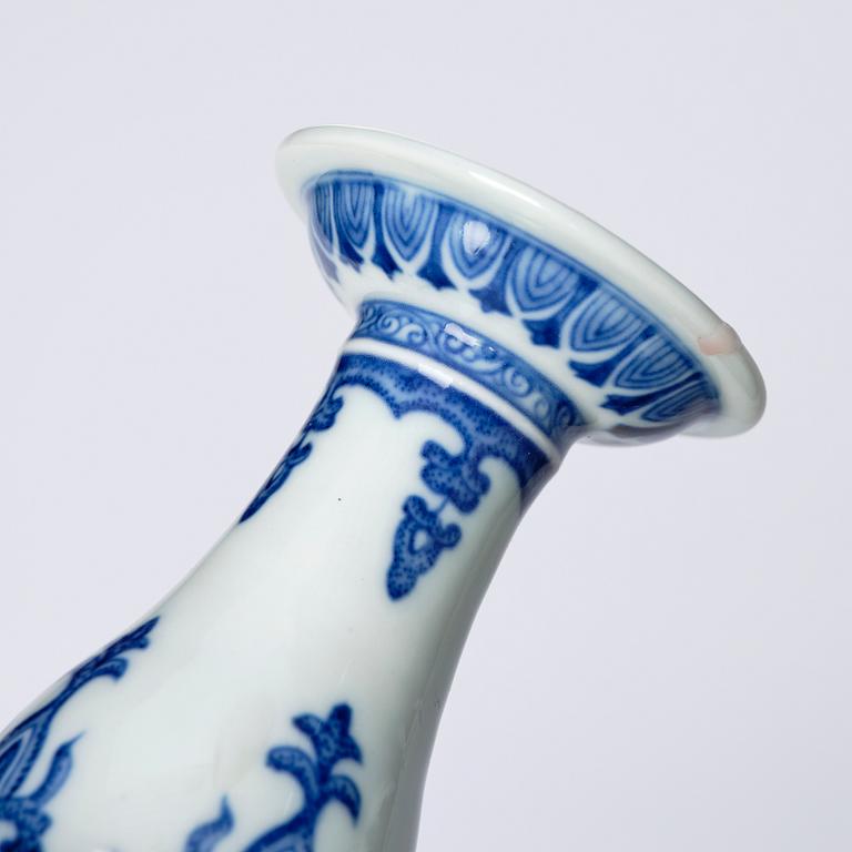 A pair of blue and white pricket candle sticks, with a poem, Qing dynasty with a Qianlong mark and of the period.